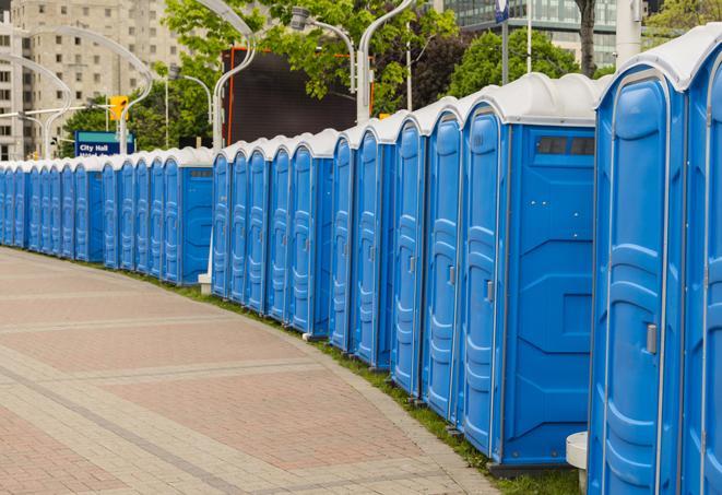 a row of portable restrooms set up for a large athletic event, allowing participants and spectators to easily take care of their needs in Bon Secour